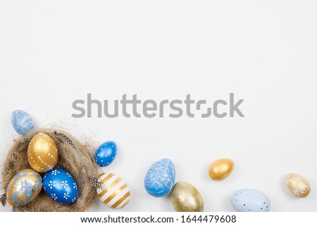 Easter golden decorated eggs in nest isolated on white background for web banner. Minimal easter concept. Happy Easter card with copy space for text. Top view, flatlay.
