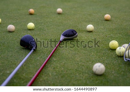 golf balls and sticks on green golf course