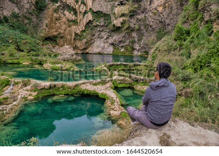 Waterfall in forest, natural background. A man at a stone in front of a waterfall, (EL SALTO-EL MECO) san luis potosi Mexico, beautiful waterfall