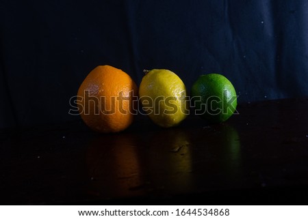 Lemon Lime Orange on black background in photography studio