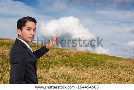 Composite image of unsmiling Asian businessman pointing