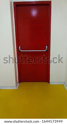 emergency exit in red in a room in the production factory building