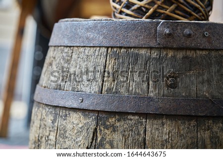 Old wooden barrel on a brown background. Royalty-Free Stock Photo #1644643675