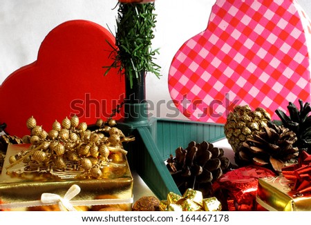 An image of Christmas showing presents and pine cones under the tree / presents and pine cones