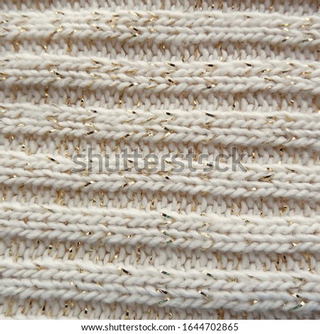    Knitted background with gold threads       