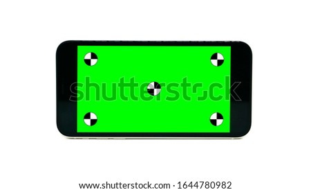 Green screen technology concept. Modern smart phone, tablet and computer mock up with green screen, alpha channel and tracking markers.