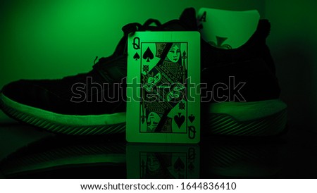 Photos of playing cards next to shoes.