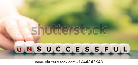 Hand turns dice and changes the word "unsuccessful" to "successful". Royalty-Free Stock Photo #1644843643