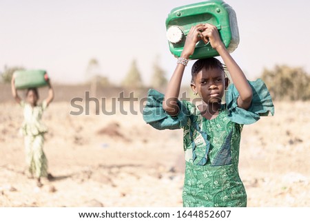Young Indigenous Young Girl Carrying fresh Water in a typical village Royalty-Free Stock Photo #1644852607