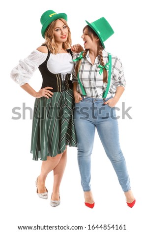 Funny young women on white background. St. Patrick's Day celebration