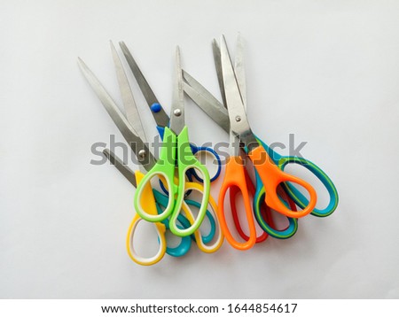 Scissors pile difference type and difference handle colors isolated on white background closeup.