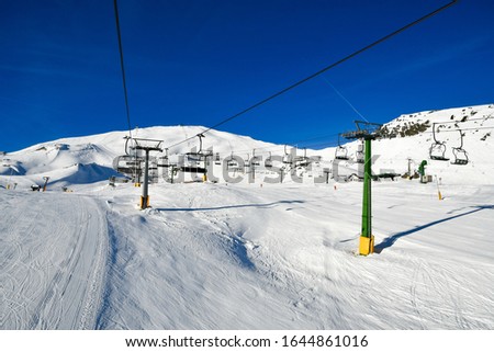Ski lifts amid the perfect snow cover of Italy's ski resorts.