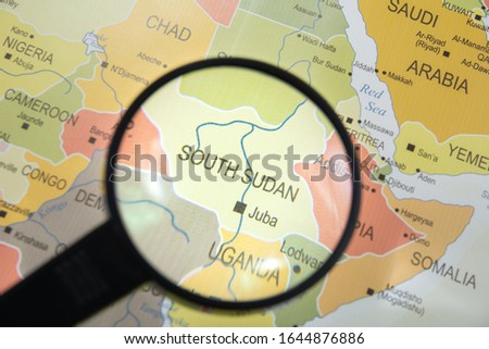 South Sudan Juba city map in focus through a magnify glass on world map