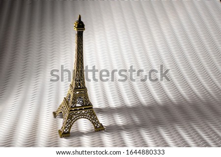 Steel Eiffel Tower Miniature isolated on a pattern white Background