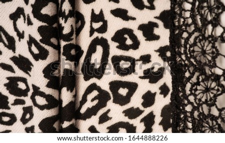 Texture, background, pattern, women's woolen shawl, black and beige, African motifs, shawl made of wool and modal with print in the form of a snake with a hem.
