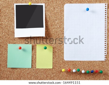 Cork message board with various paper notes