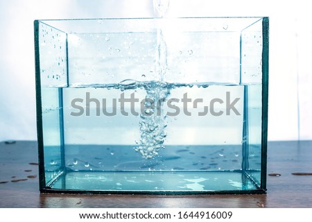 Moving water waves and bubbles bursting in the aquarium