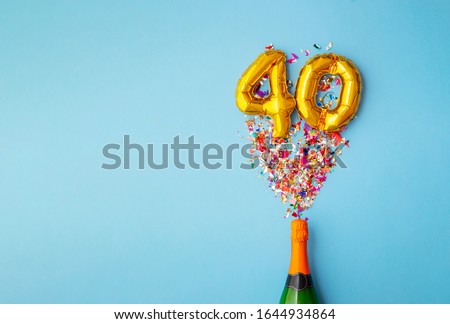 40th anniversary champagne bottle balloon pop Royalty-Free Stock Photo #1644934864
