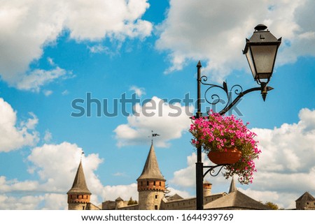 fairy tale background frame work landmark outside view street lantern flower vase objects and castle towers silhouette shapes in vivid colorful summer bright day time with empty copy space for text