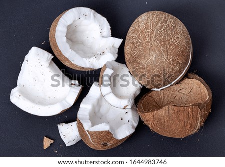 
Organic coconut close-up on a dark background. Health content.
An open coconut with a shell. Exotic food.