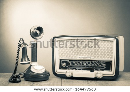 Vintage radio and telephone on table old style photo