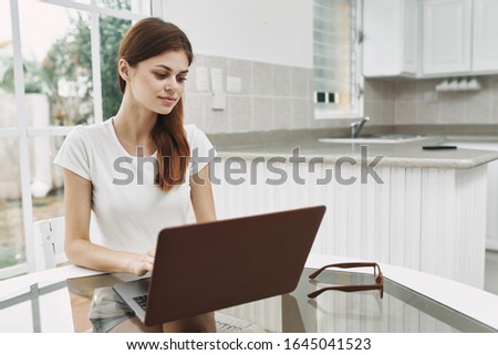 Woman at home in front of laptop working freelance