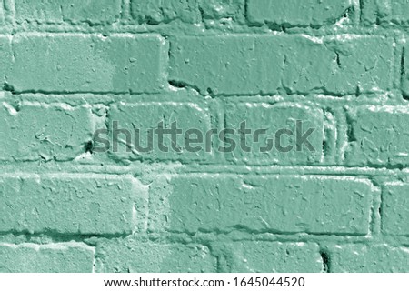 Painted brick wall close up. Abstract background green color toned