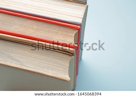 Three books on color background, closeup