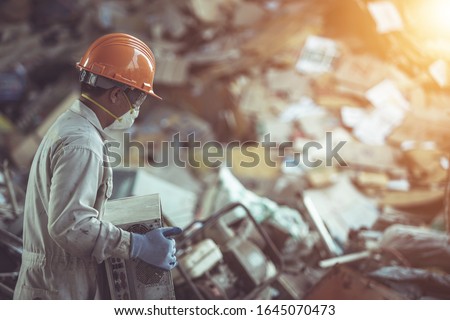 Electronic waste management of worker in the uniform Royalty-Free Stock Photo #1645070473