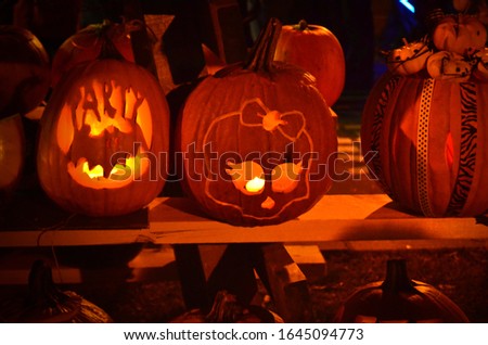 halloween themed carved pumpkins on a shelf