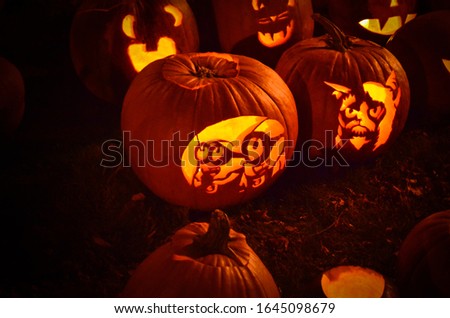 glowing carved halloween pumpkins on the ground