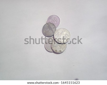 some coins with a white background