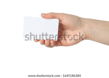 Female hand holding blank business card, isolated on white background