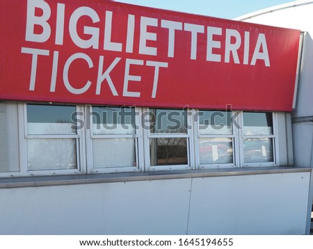 Closed ticket box office windows under big red sign