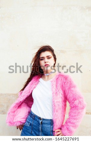 young pretty teenage brunette girl happy smiling outside, lifestyle people concept