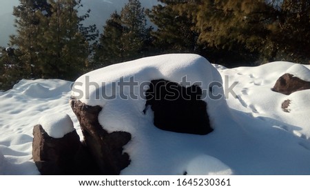 This is the picture of snow on the rock .Which is looks beautiful.With the light of sun.
