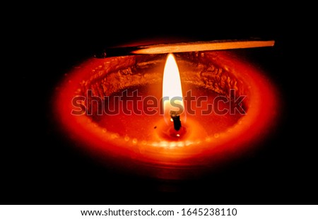 Creative shot of a lit candle with matchstick