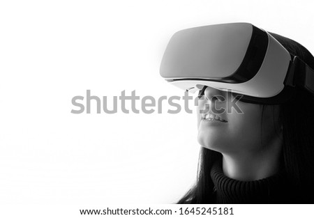 Beautiful happy woman using VR helmet on white background. Girl in glasses of virtual reality. Augmented reality, game, future technology concept. VR. Free space for text.