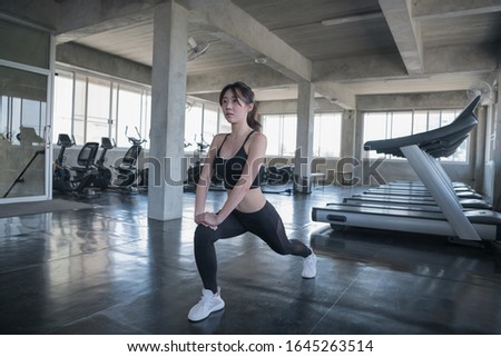 Asian women stretching in the gym.