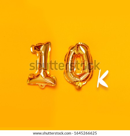 10,000 gold sign balloon on a yellow background. Subscribe concept. Holiday poster for banner, poster