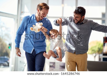 Happy Child girl at shopping  with gay parents.family having fun at shopping. Royalty-Free Stock Photo #1645286746