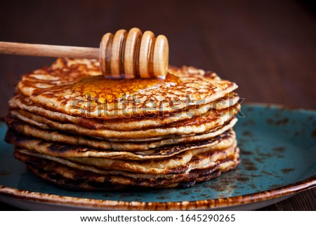  Pancakes drenched with honey,
selective focus, shallow depth of field
