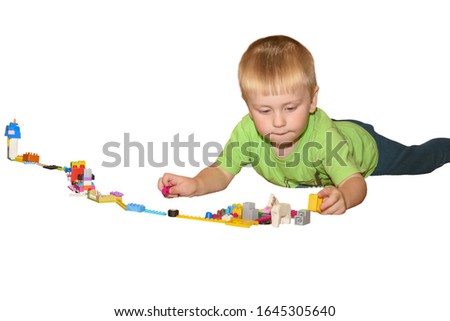 Little boy plays with colorful blocks at home. Photo isolated