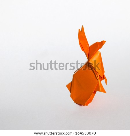 Origami orange rabbit isolated on white