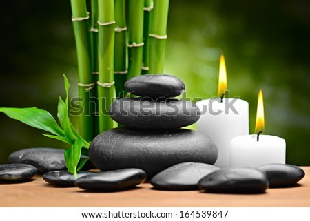 zen basalt stones and candle on the wood