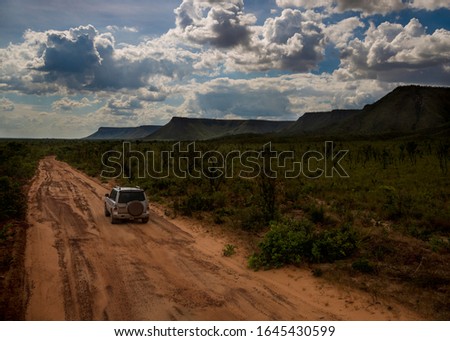 off road car on sandy road with mountains in the background - Jalapão Brazil