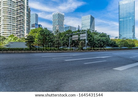 empty road and modern office block buildings against sky, china