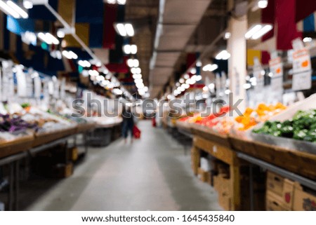 Blurred image of fresh farmers market sell variety of organic fruits and vegetables.