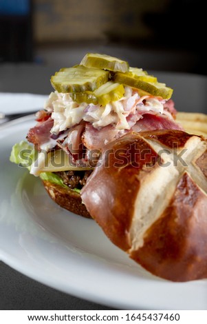 A view of pastrami burger plate in a restaurant or kitchen setting.