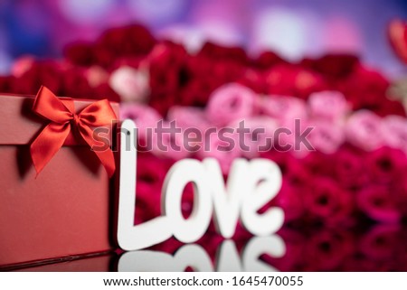 Romantic love concept. Roses, gifts, bokeh background.